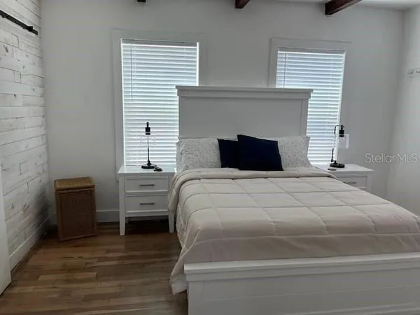 a bedroom with a bed and a fireplace