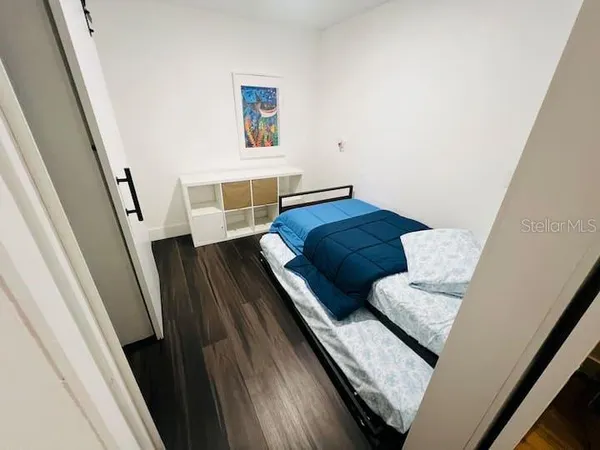 a bedroom with a bed and a couch