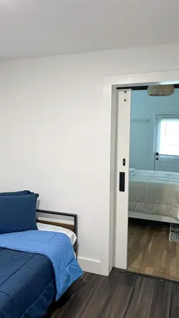 a bedroom with a bed and wooden floor