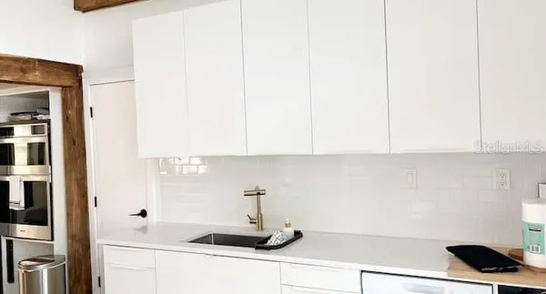 a kitchen with a sink and cabinets