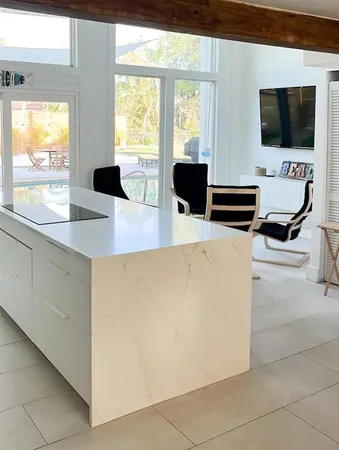 a view of a livingroom with workspace and a window