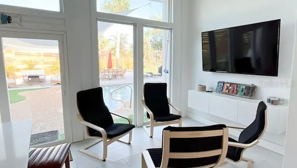 a living room with a flat screen tv and a large window