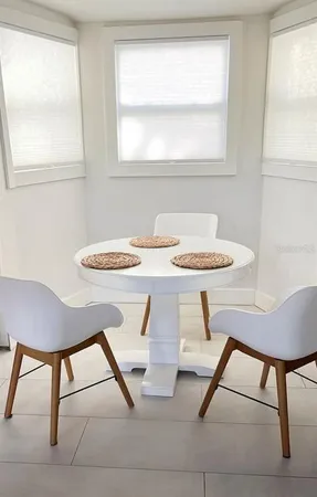 a view of a dining room with furniture and a window
