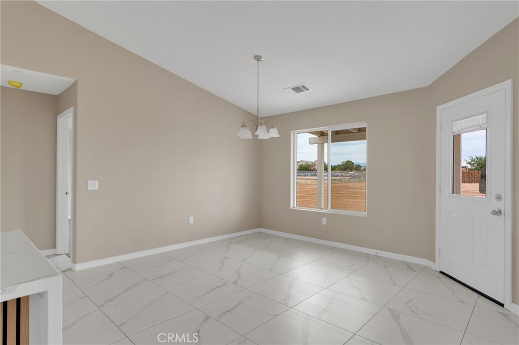 12584 Mesquite Road Apple Valley, CA 92308 - Photo 12 of 44 a view of an empty room with a window