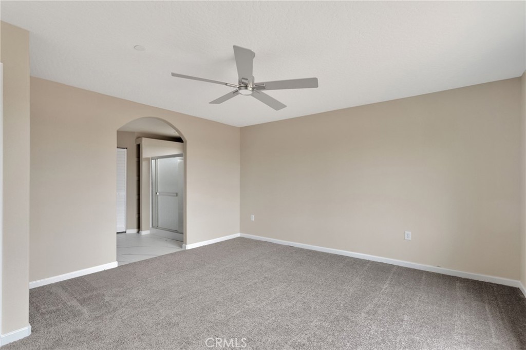 12584 Mesquite Road Apple Valley, CA 92308 - Photo 15 of 44 an empty room with a ceiling fan and a window