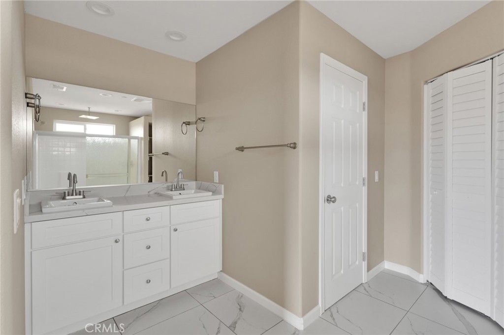 12584 Mesquite Road Apple Valley, CA 92308 - Photo 17 of 44 a bathroom with a double vanity sink and mirror
