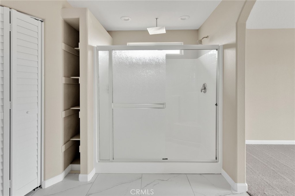12584 Mesquite Road Apple Valley, CA 92308 - Photo 19 of 44 a bathroom with a glass shower door