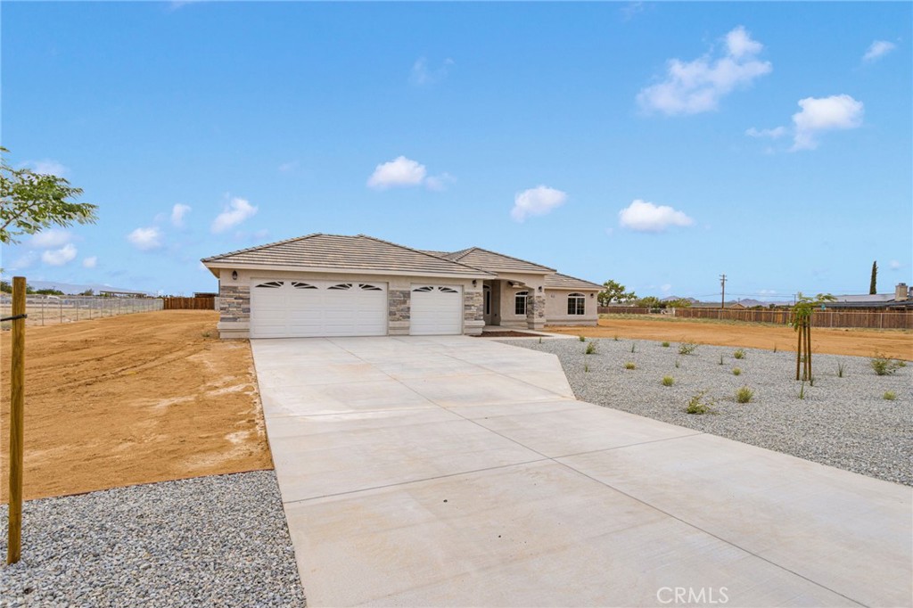 12584 Mesquite Road Apple Valley, CA 92308 - Photo 2 of 44 a front view of a house with a yard