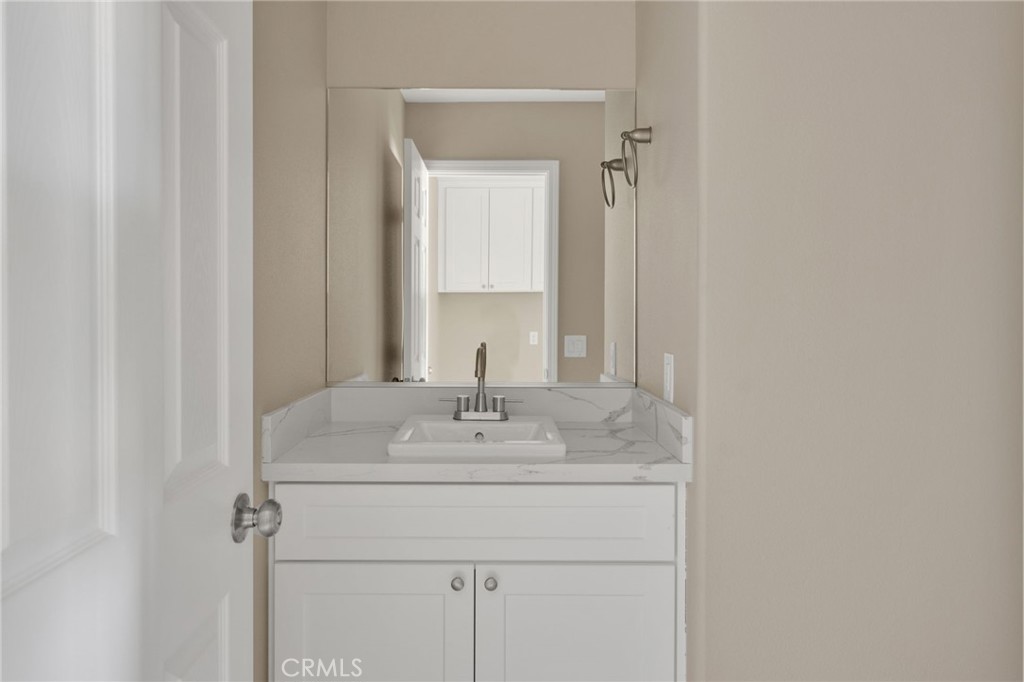 12584 Mesquite Road Apple Valley, CA 92308 - Photo 21 of 44 a bathroom with a sink and a mirror