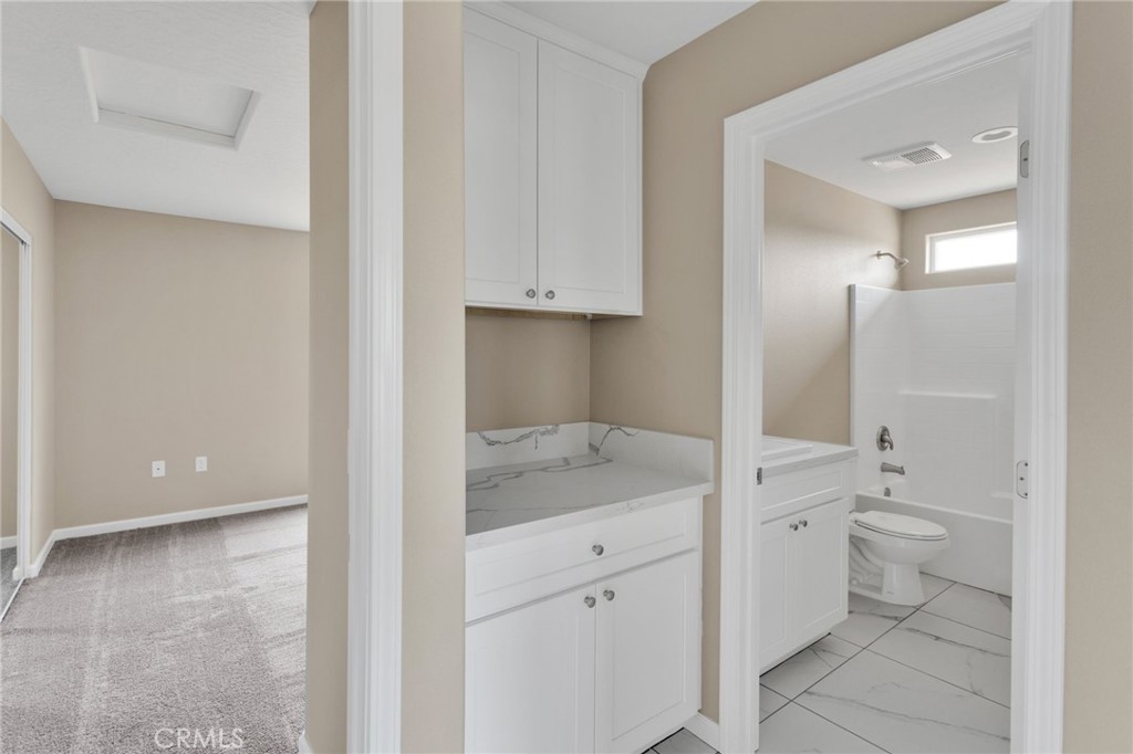 12584 Mesquite Road Apple Valley, CA 92308 - Photo 24 of 44 a bathroom with a granite countertop sink mirror and toilet