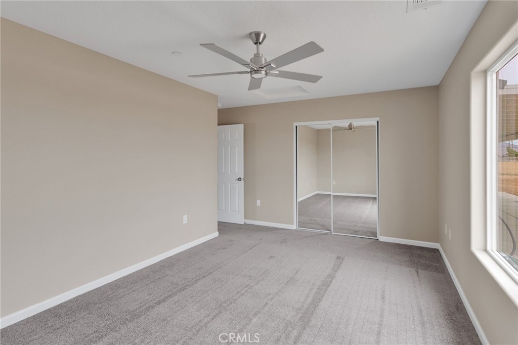 12584 Mesquite Road Apple Valley, CA 92308 - Photo 26 of 44 an empty room with windows and closet