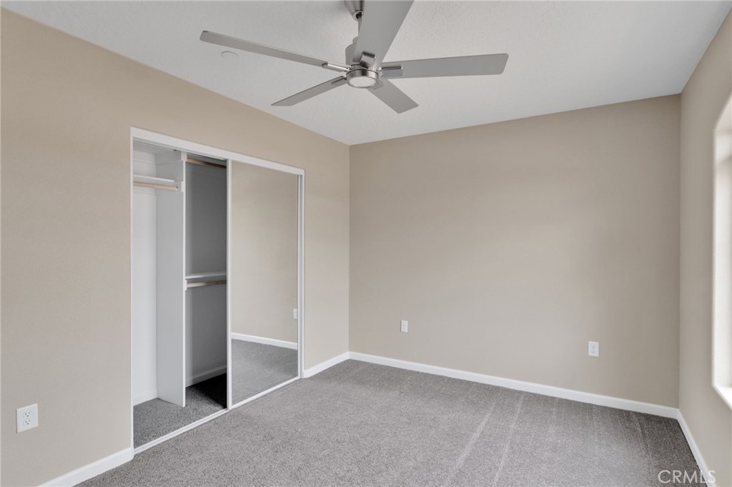 12584 Mesquite Road Apple Valley, CA 92308 - Photo 28 of 44 an empty room with windows and fan