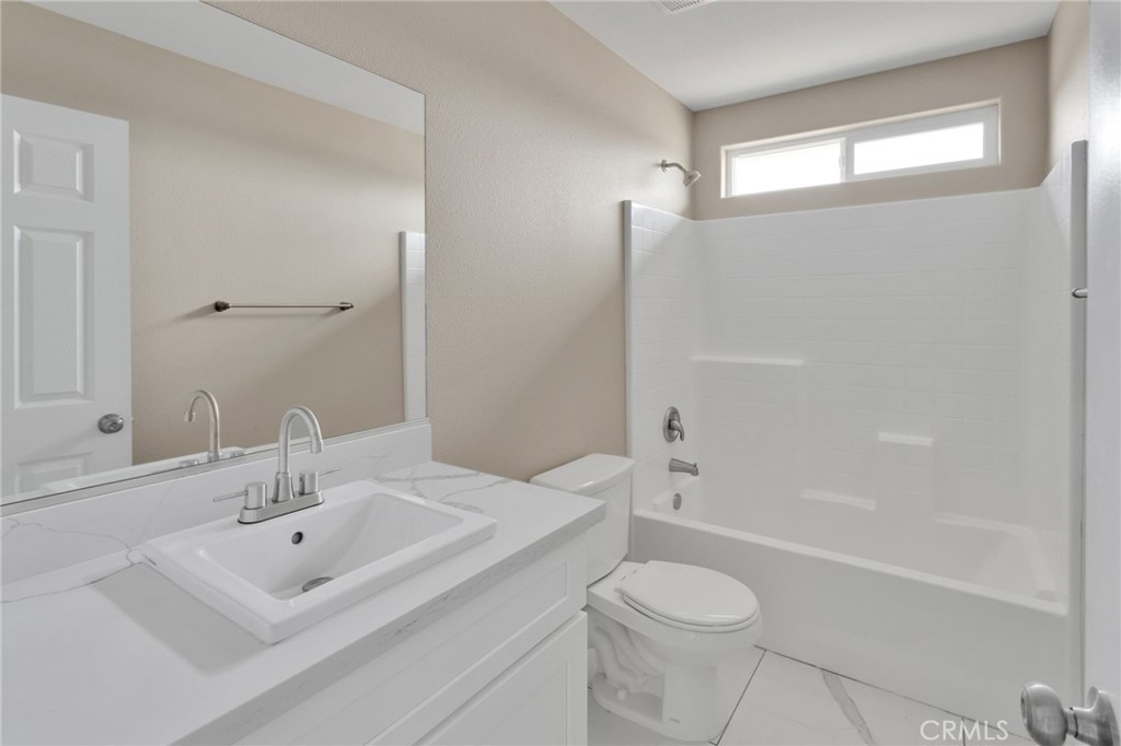 12584 Mesquite Road Apple Valley, CA 92308 - Photo 29 of 44 a bathroom with a sink toilet and shower