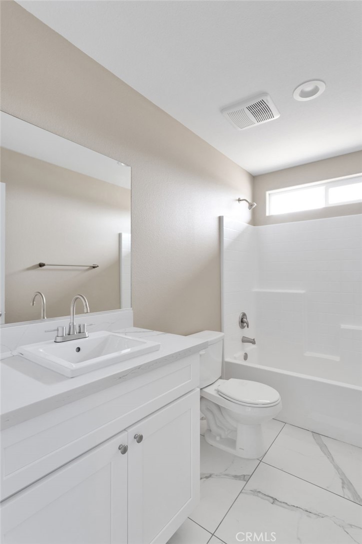 12584 Mesquite Road Apple Valley, CA 92308 - Photo 30 of 44 a bathroom with a sink a toilet and shower