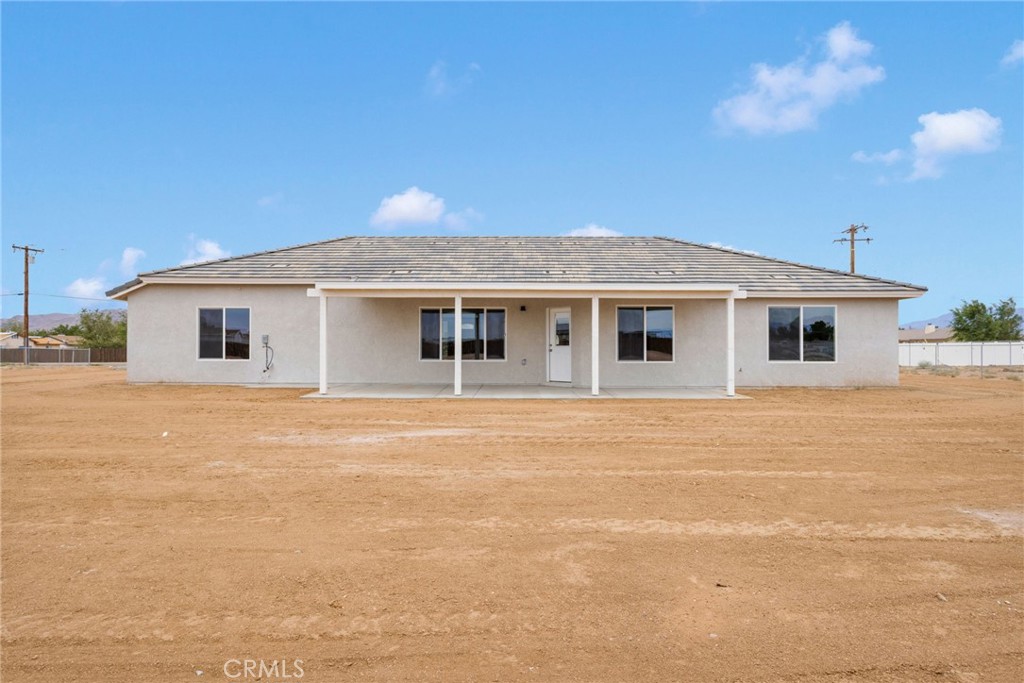 12584 Mesquite Road Apple Valley, CA 92308 - Photo 34 of 44 a front view of a house with a garden