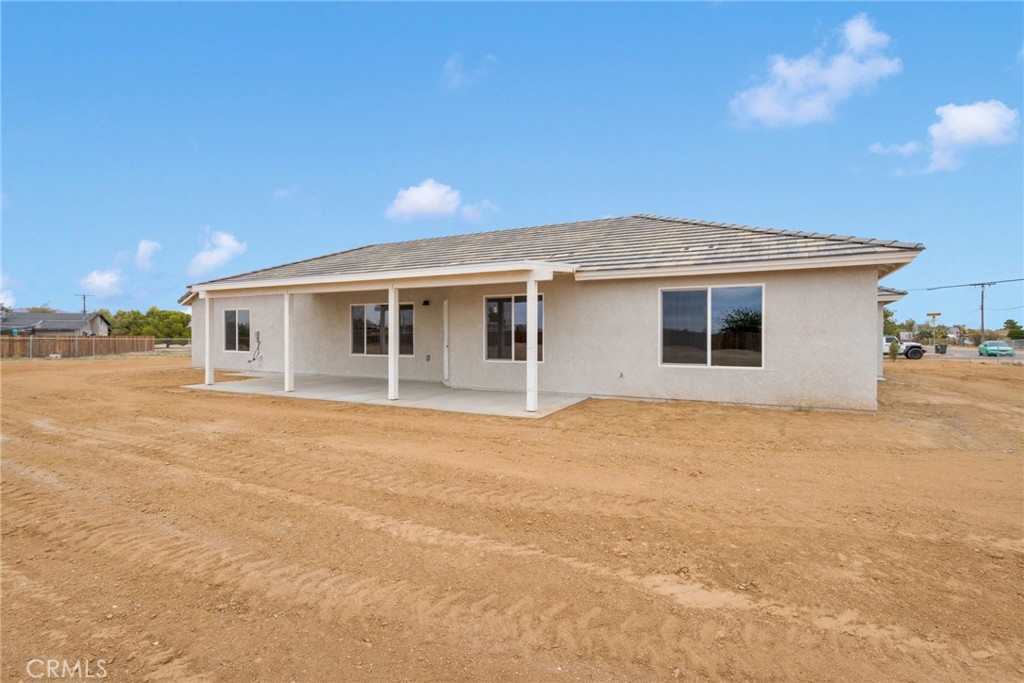 12584 Mesquite Road Apple Valley, CA 92308 - Photo 35 of 44 a front view of the house with a yard
