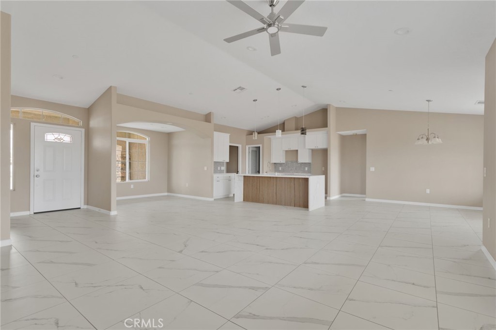 12584 Mesquite Road Apple Valley, CA 92308 - Photo 5 of 44 a view of a livingroom with a kitchen and a fireplace