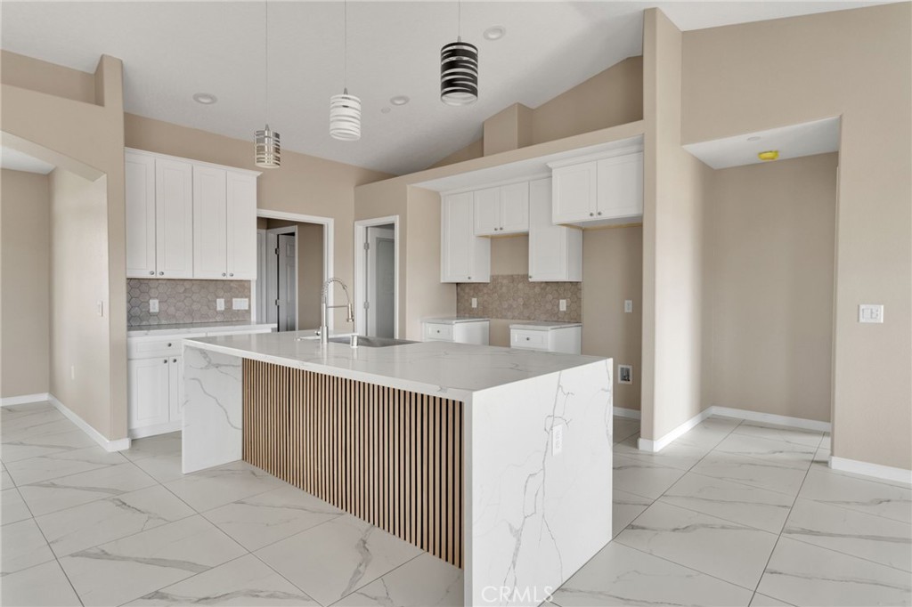 12584 Mesquite Road Apple Valley, CA 92308 - Photo 7 of 44 a kitchen with kitchen island cabinets and refrigerator