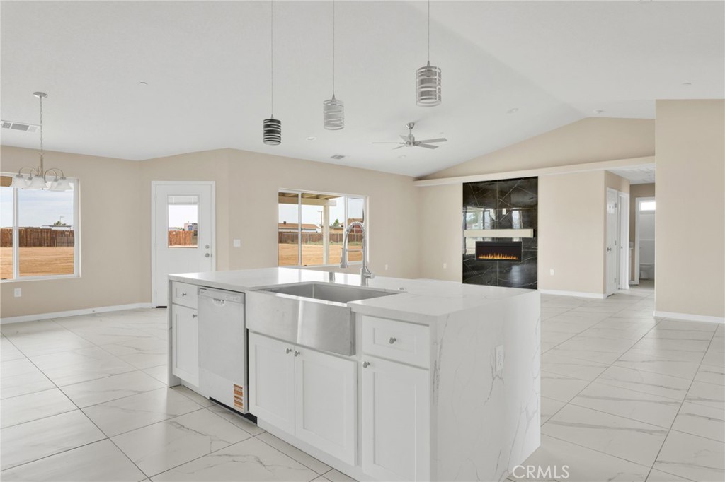 12584 Mesquite Road Apple Valley, CA 92308 - Photo 9 of 44 a kitchen with granite countertop white cabinets and white appliances
