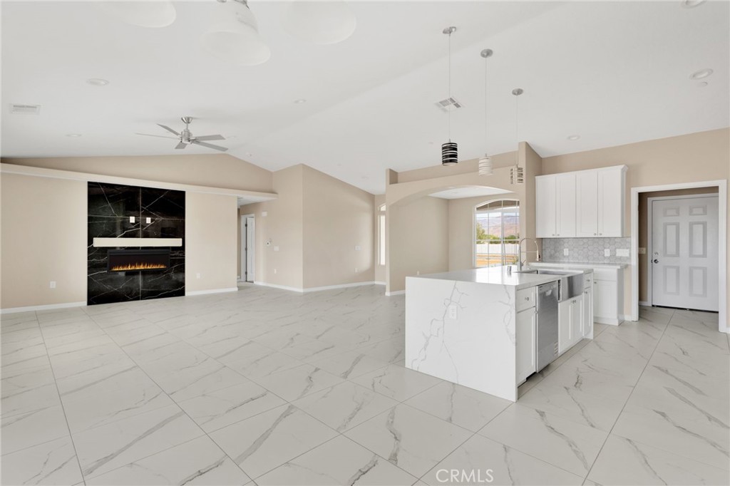 12584 Mesquite Road Apple Valley, CA 92308 - Photo 10 of 44 a kitchen with granite countertop white cabinets and white appliances