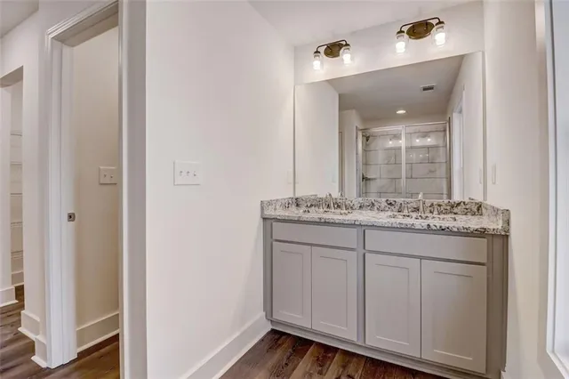 a bathroom with a granite countertop sink and a mirror