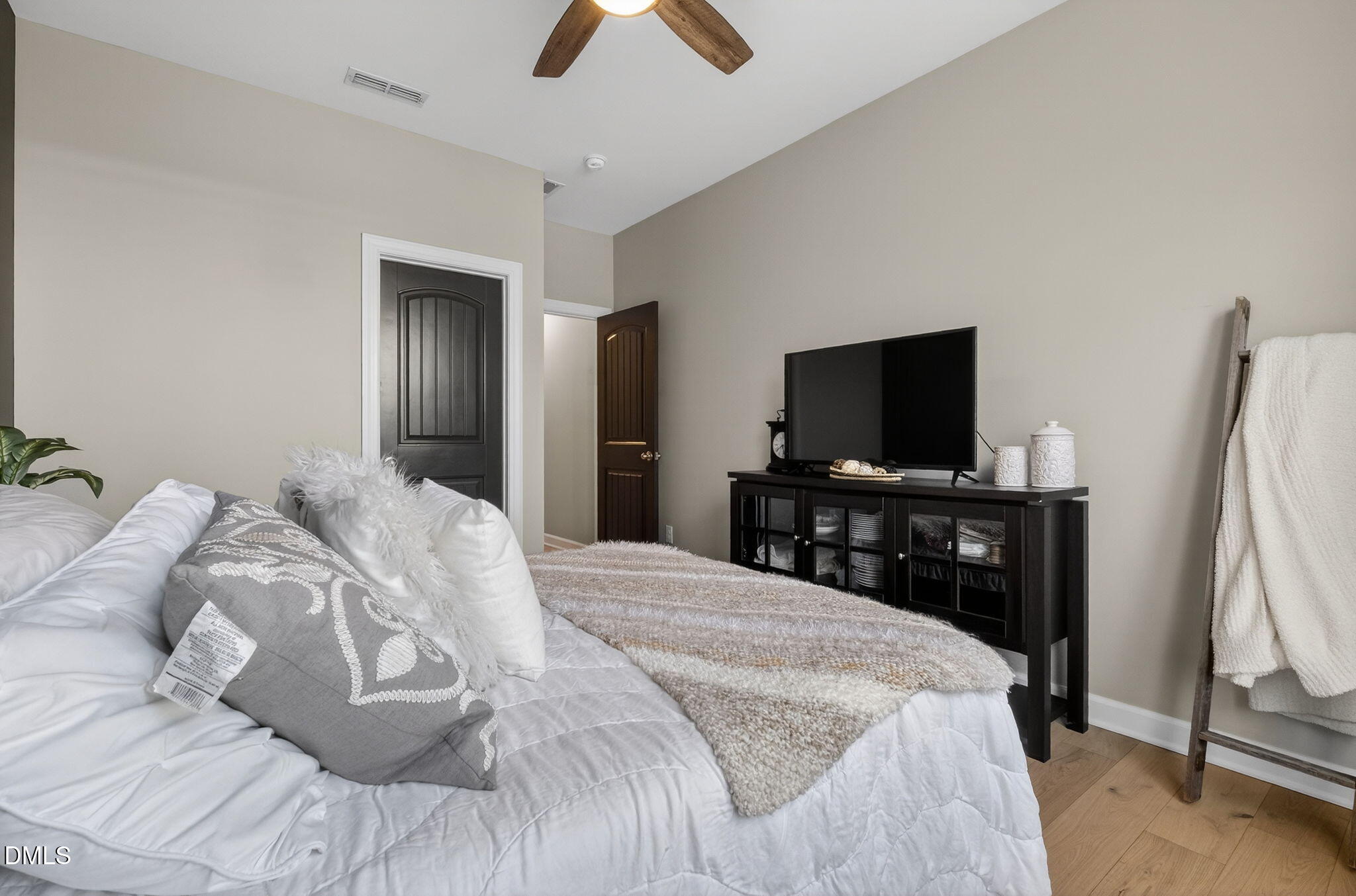 801 Tree Green Lane Wake Forest, NC 27587 - Photo 13 of 28 a bedroom with a bed and a flat screen tv