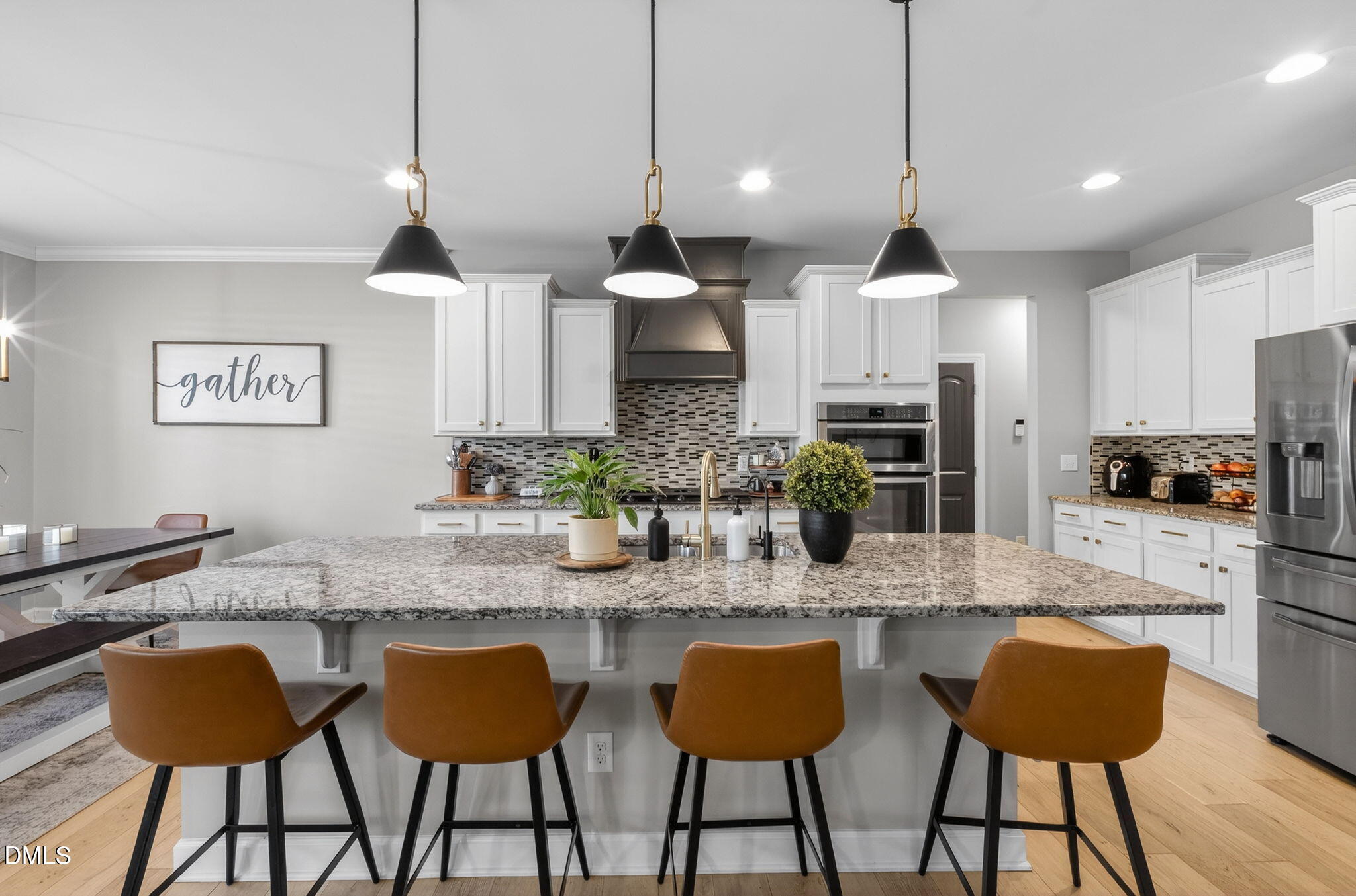 801 Tree Green Lane Wake Forest, NC 27587 - Photo 8 of 28 a kitchen with granite countertop a stove a sink a center island a dining table and chairs