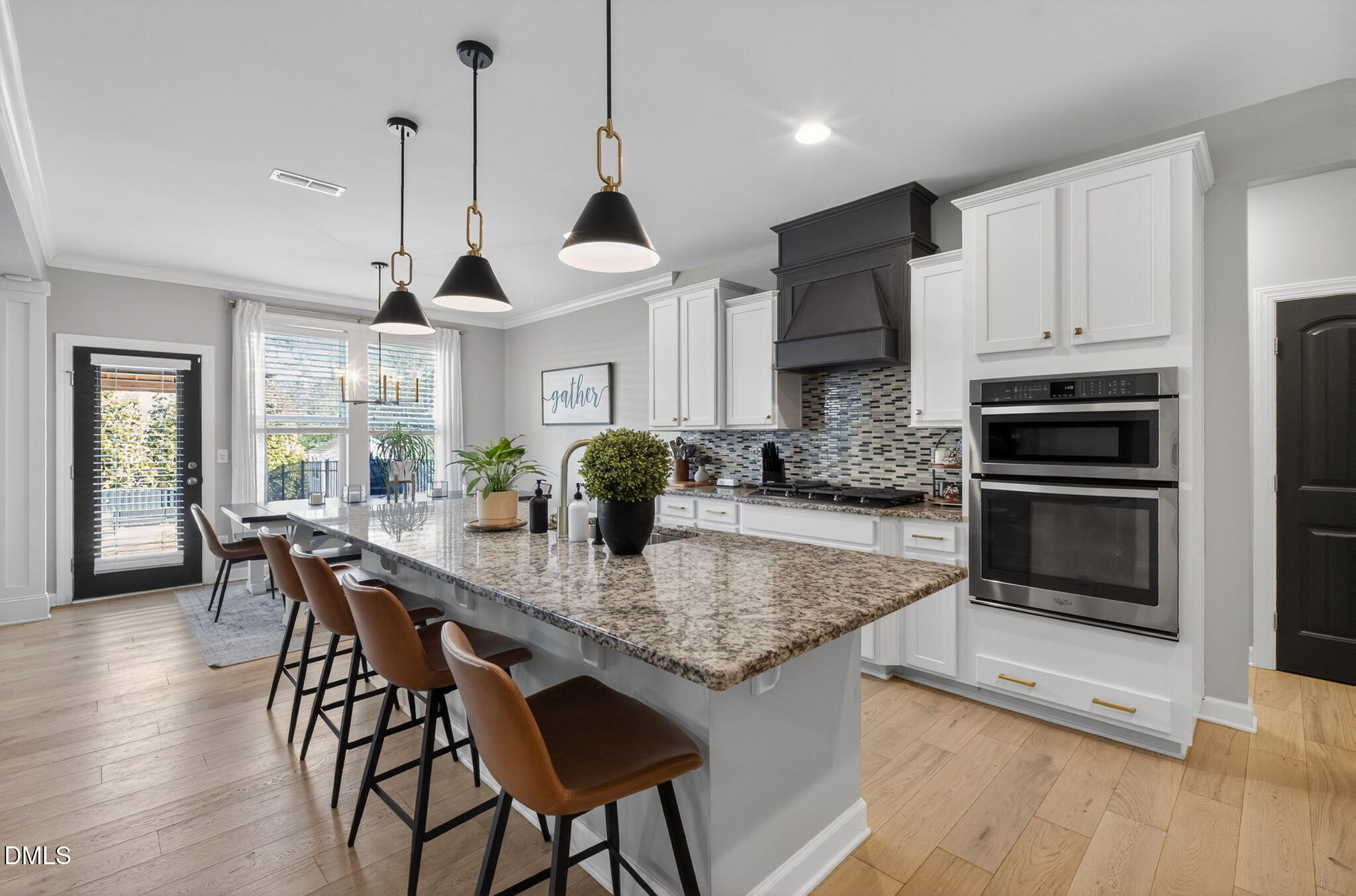801 Tree Green Lane Wake Forest, NC 27587 - Photo 9 of 28 a kitchen with stainless steel appliances granite countertop a stove a kitchen island a stove and a wooden floors