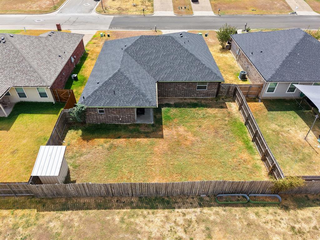 10620 Granada Drive Waco, TX 76708 - Photo 33 of 38 Fenced backyard with a storage shed and a covered patio area