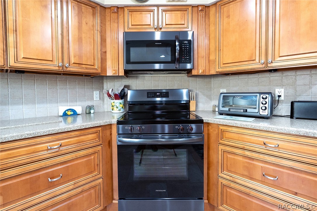 800 Balmoral Court Inverness, FL 34453 - Photo 15 of 72 a kitchen with stainless steel appliances granite countertop cabinets and a microwave oven