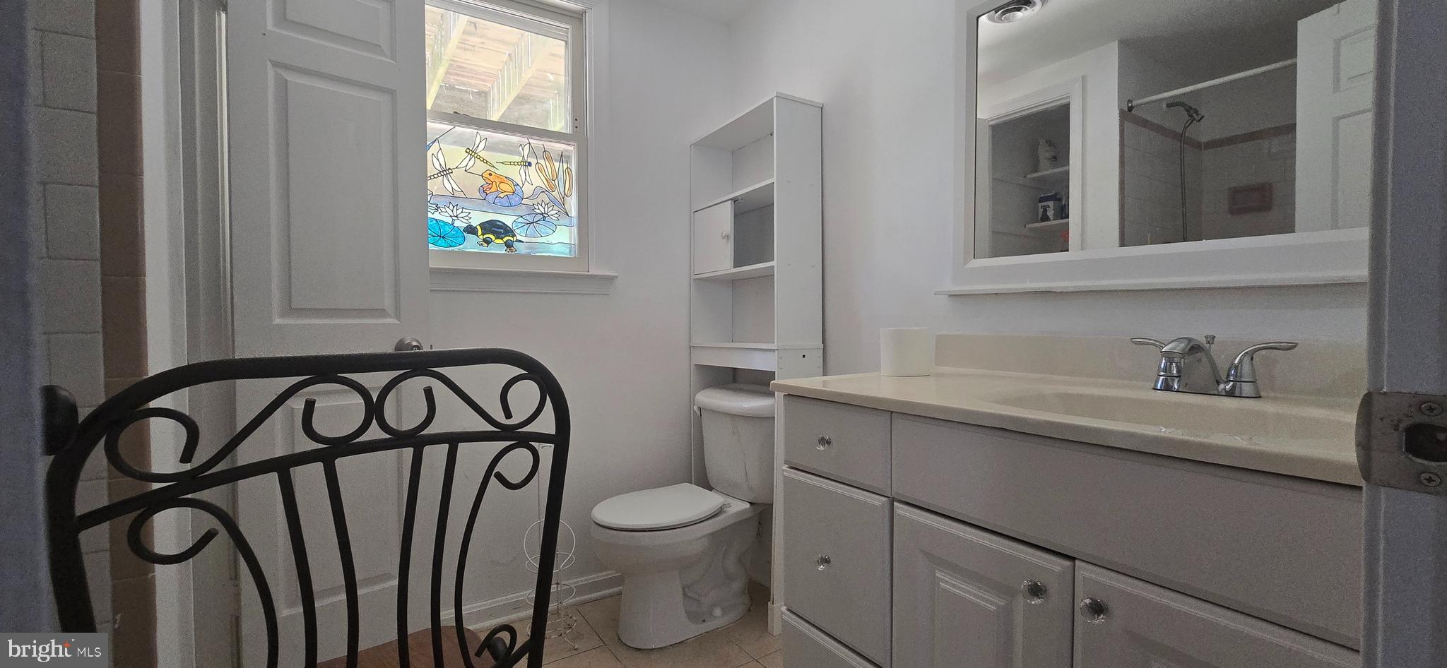 9508 Mellow Court Laurel, MD 20723 - Photo 12 of 23 a bathroom with a toilet sink a mirror and a window