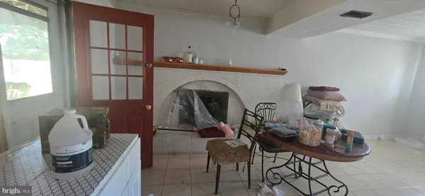 a living room with furniture and a mirror