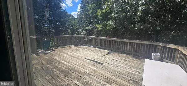 a wooden deck with sunset view