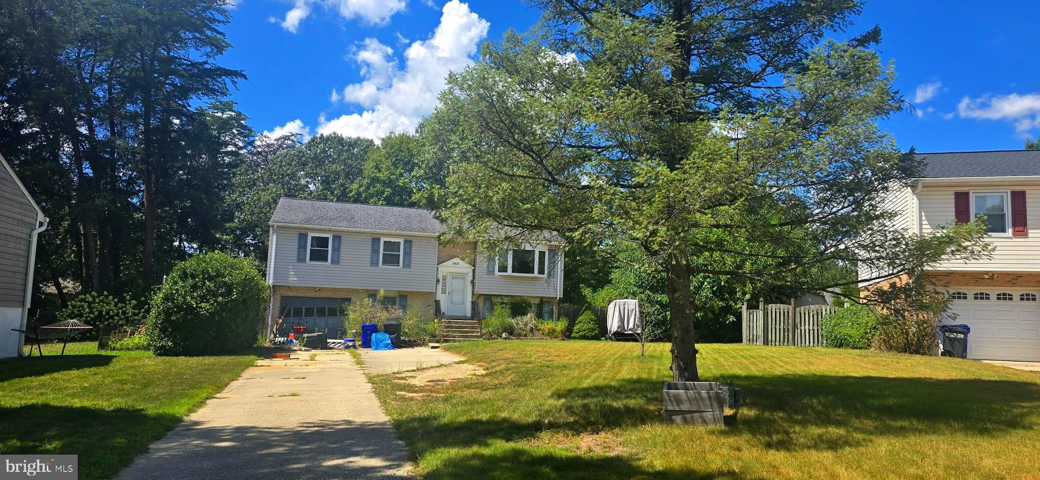 9508 Mellow Court Laurel, MD 20723 - Photo 2 of 23 a front view of a house with a yard garage and outdoor seating