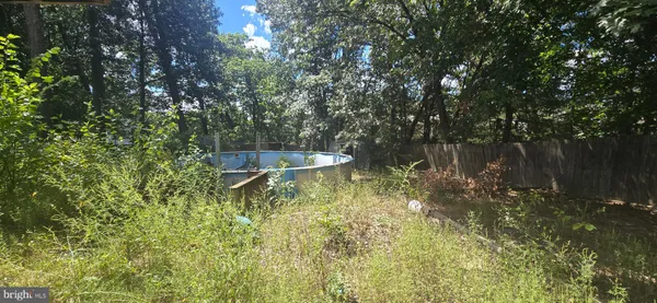 a front view of house with a garden