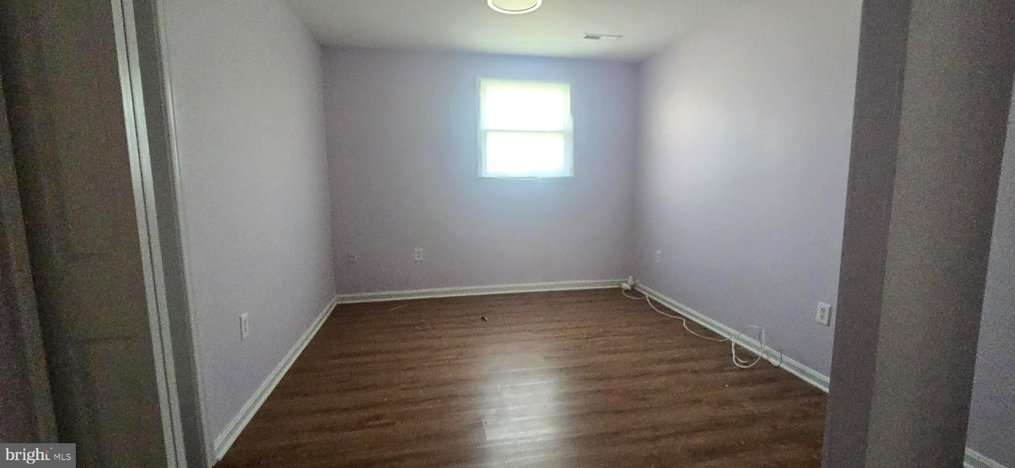 9508 Mellow Court Laurel, MD 20723 - Photo 8 of 23 a view of empty room with wooden floor and fan