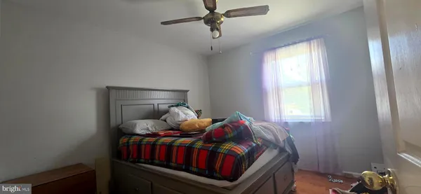 a bedroom with a bed and window