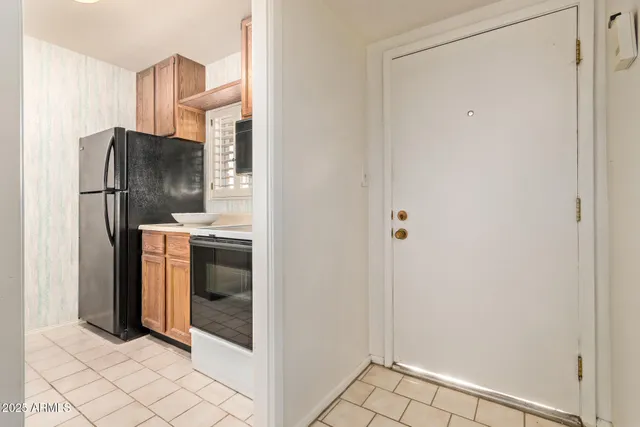 a kitchen with metallic refrigerator freezer and a dishwasher