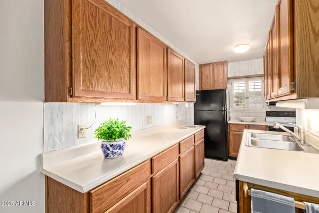a kitchen with stainless steel appliances granite countertop a sink a stove and a refrigerator