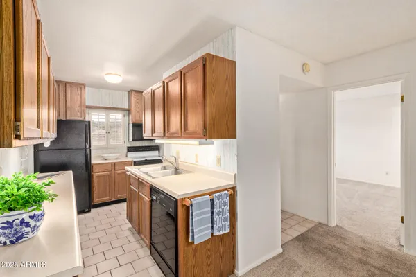a kitchen with a sink stove and refrigerator