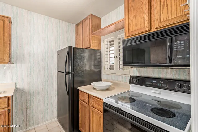 a kitchen with stainless steel appliances granite countertop a refrigerator stove and microwave