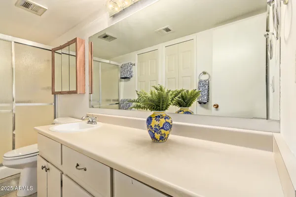 a bathroom with a sink a toilet and shower curtain
