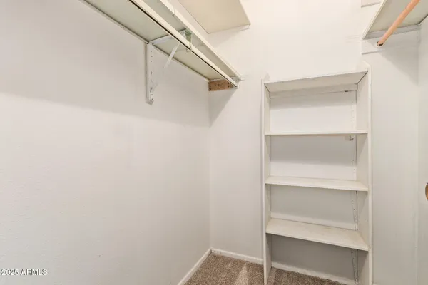 a spacious bedroom with a bed and a couch