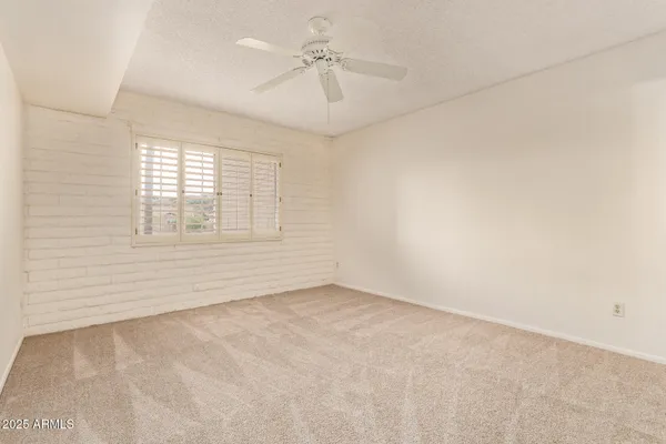 a view of empty room with a fan