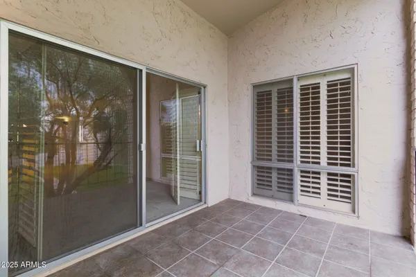 a view of a balcony with a tree