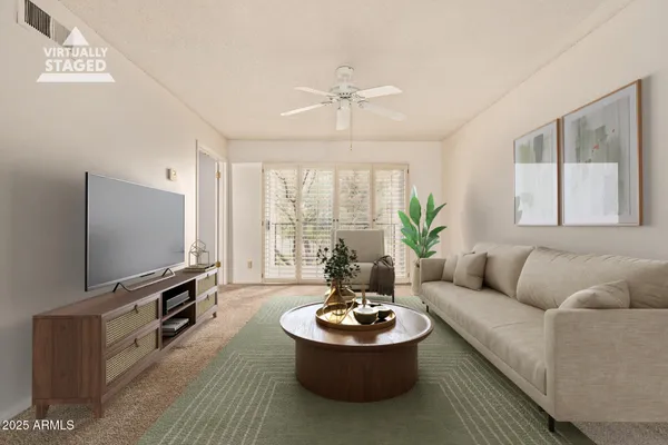 a living room with furniture a flat screen tv and a large window