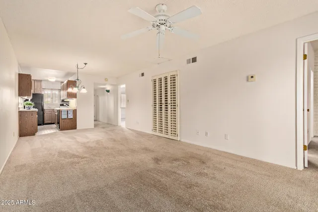 a view of a kitchen with a sink and a refrigerator
