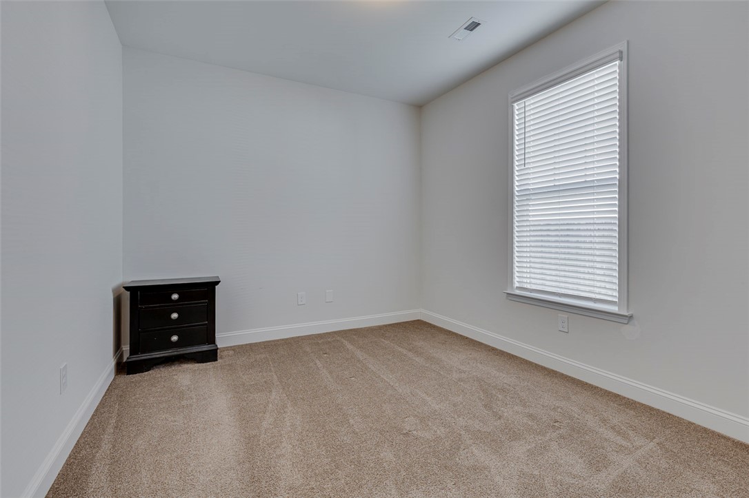 141 Capslock Trail Pendleton, SC 29670 - Photo 13 of 38 A well-proportioned bedroom with neutral carpet and a window offering natural illumination.