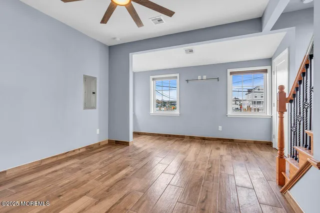 a view of a livingroom with a ceiling fan and wooden floor