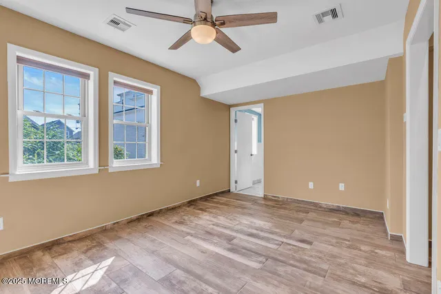 a spacious bathroom with a granite countertop sink mirror and toilet